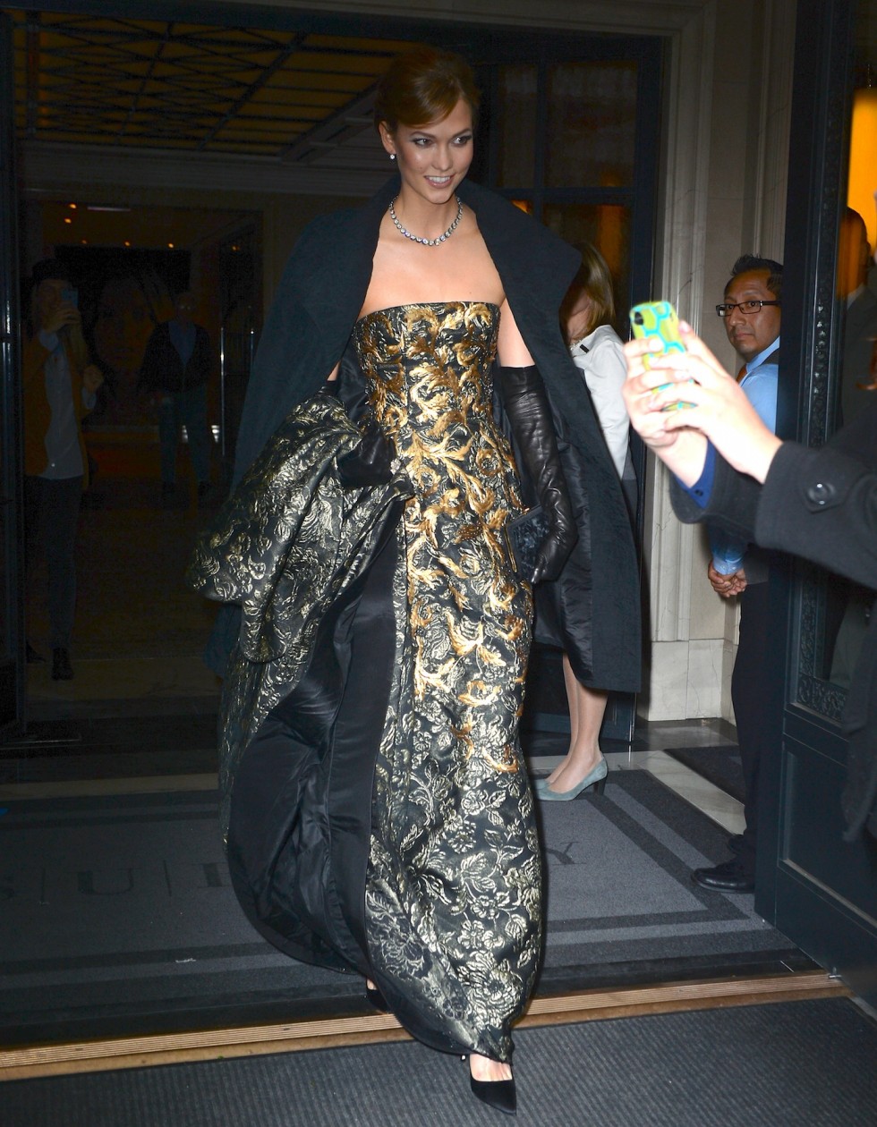 Karlie Kloss towers in gold floral dress